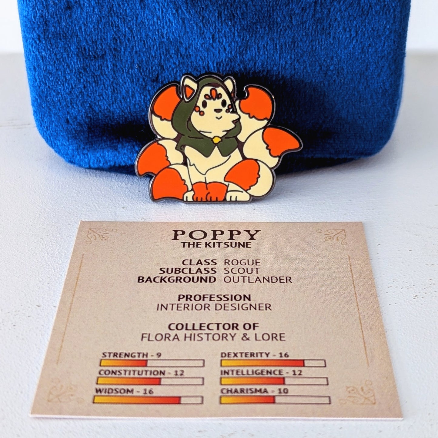 collectors guild cafe character pin with ttrpg stats card poppy the kitsune rogue